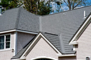 A close up of a grey asphalt shingle roof on a home. 